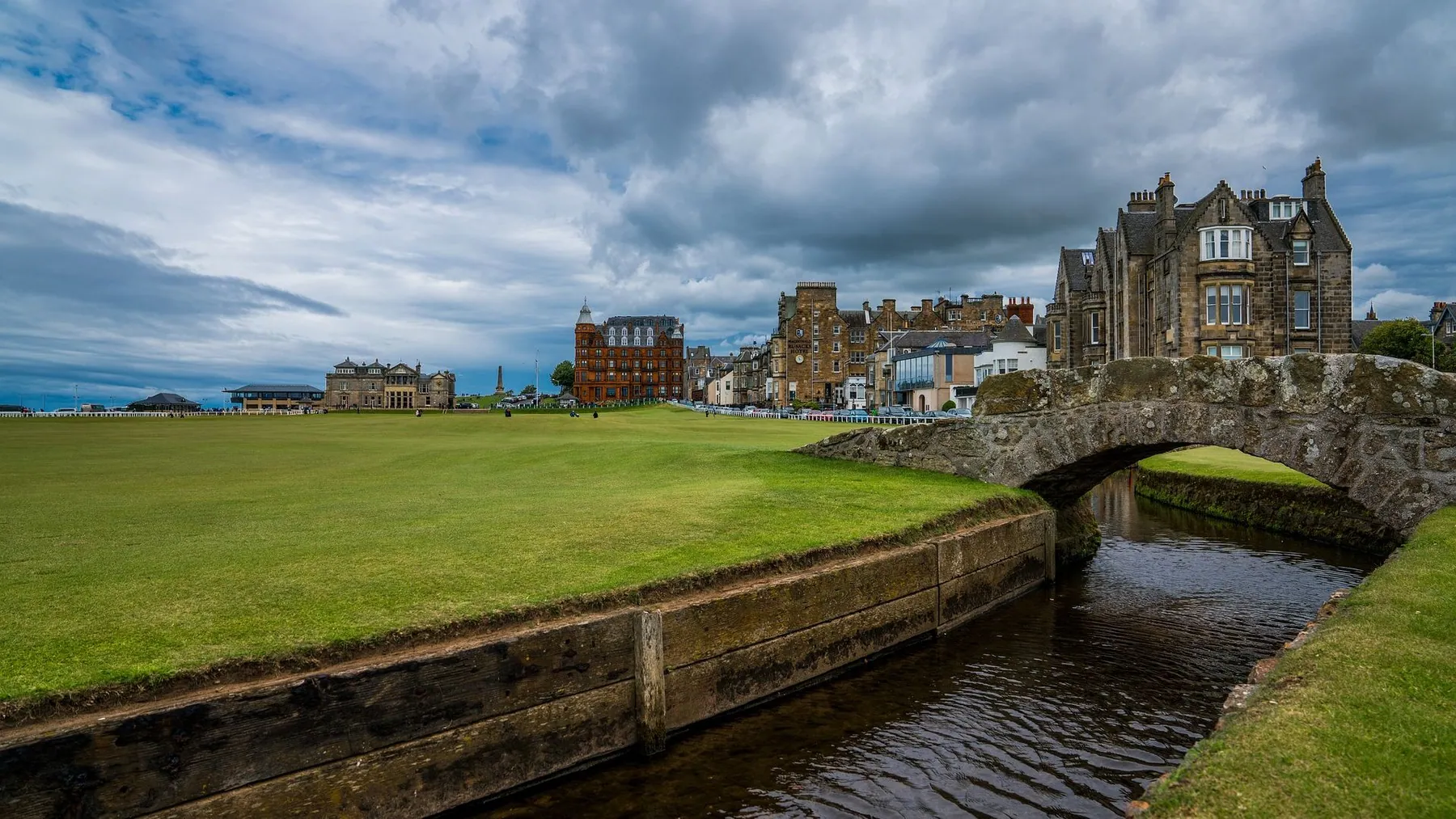 The Swilcan Bridge and the eighteenth fairway of the Old Course at St Andrews, with the town behind
